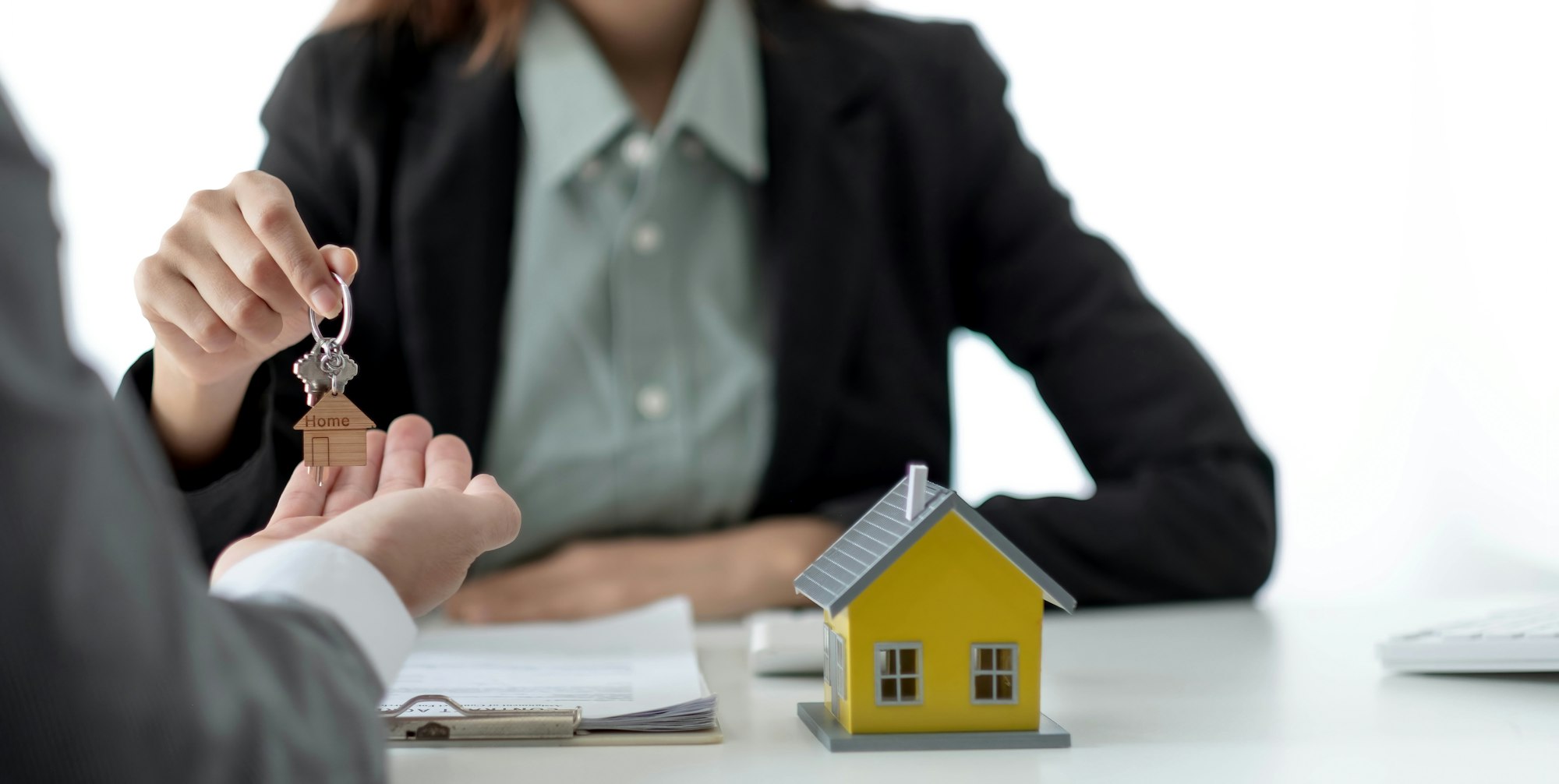 Close up hand of home,apartment agent or realtor was holding the key to the new landlord,tenant or