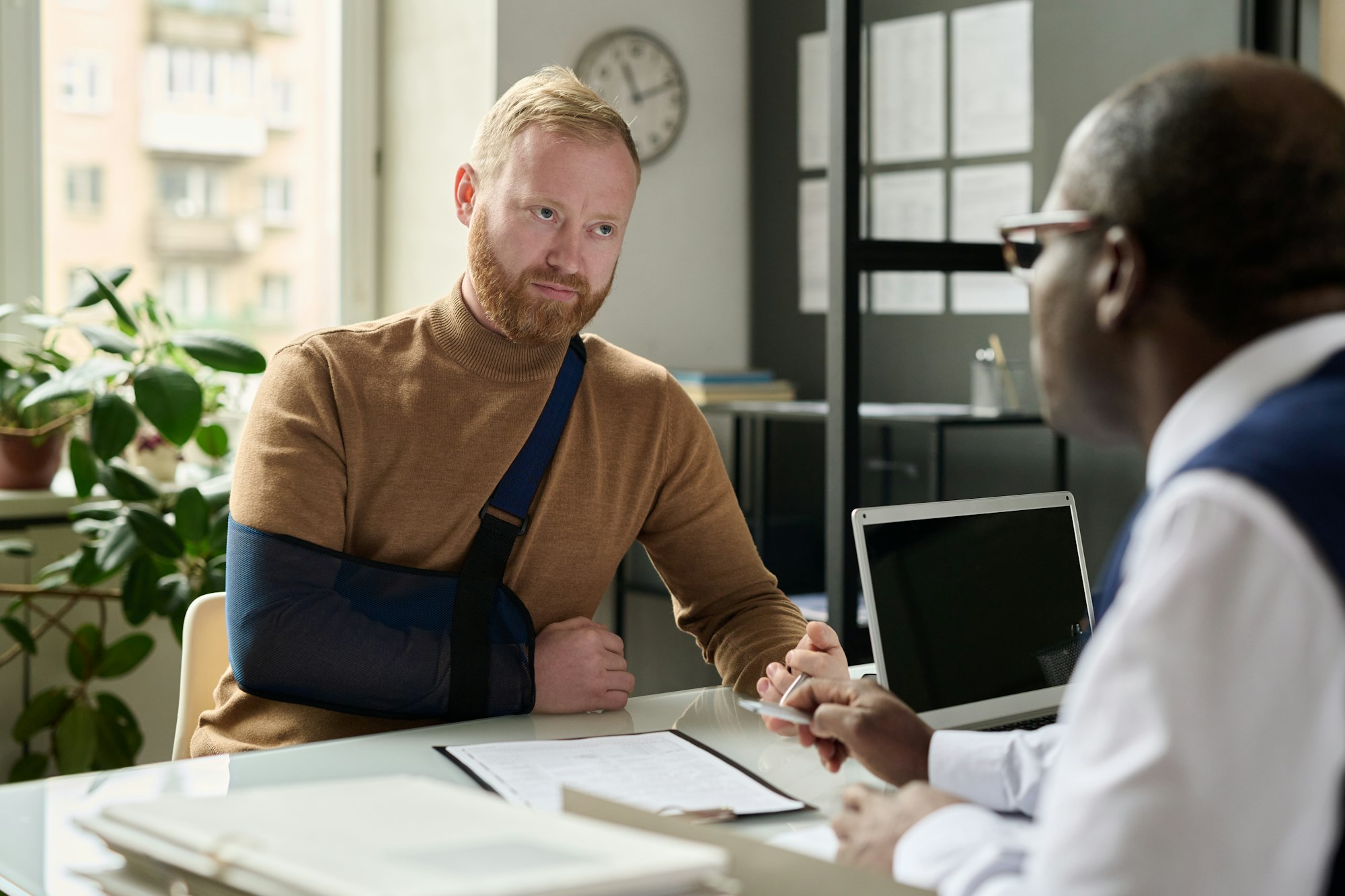 Man talking to insurance broker after accident